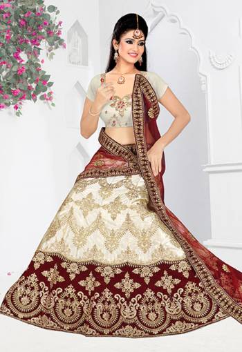 Flaunt Your Rich And Elegant Taste With Some Subtle Color Pallet In Your Bridal Wear. Grab This Heavy Designer Lehenga Choli In Grey Color Paired With Maroon Colored Dupatta. Its Blouse Are Lehenga are Satin Silk Based Paired With Net Fabricated Dupatta. 