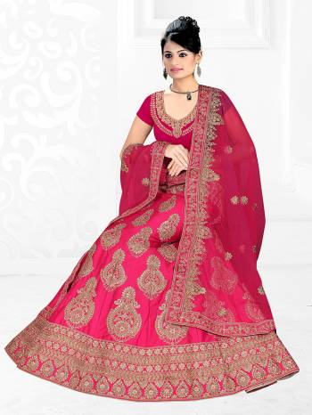 Here Is A Very Beautiful Heavy Designer Bridal Lehenga Choli In All Over Dark Pink Color. Its Blouse And Lehenga Are Fabricated On Satin Silk Paired With Net Fabricated Dupatta. It Is Beautified With Heavy Embroidery Giving It An Attractive Look. 