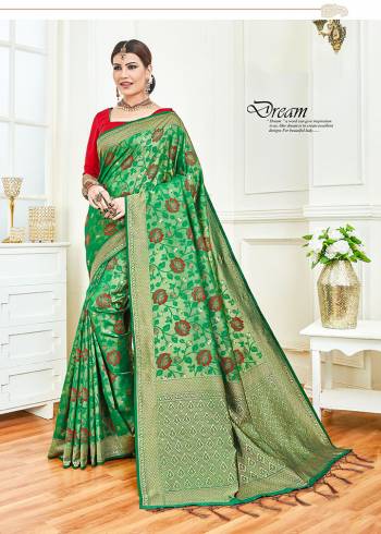 For An Attractive Festive Look, Grab This Designer Silk Based Saree In Green Color Paired With Contrasting Red Colored Blouse. This Saree And Blouse silk Based Beautified With Intricate Weave. 