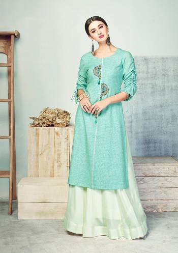 Look Beautiful In This Designer Readymade Pair Of Kurti And Skirt In Shades Of Blue. This Cotton Based Kurti Is In Aqua Blue Color Paired With Rayon Fabricated Baby Blue Colored Skirt. This Kurti Is Beautified With Thread Work And Fancy Sleeve Pattern. 