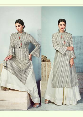 Celebrate This Festive Season With Beauty And Comfort Wearing This Designer Readymade Pair Of Kurti And Skirt In Grey And Off-White Color. This Kurti Is Fabricated On Handloom Cotton Paired With Rayon Fabricated Skirt. Its Elegant Lining Print And Thread Work Gives A Rich Look. 