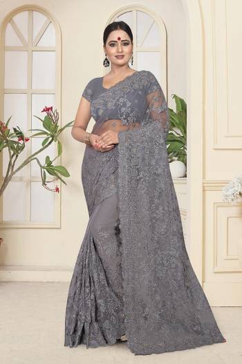 Flaunt Your Rich And Elegant Taste Wearing This Heavy Designer Saree In All Over Grey Color. This Heavy Tone To Tone Embroidered Saree And Blouse are Fabricated On Net. Its Fabric Is Light In Weight And Easy To Carry Throughout The Gala