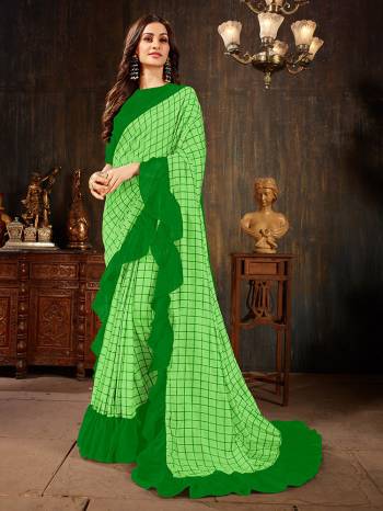 Celebrate This Festive Season With This Treding Ruffle Saree In Parrot Green Color Paired With Green Colored Blouse. This Saree And Blouse Are Silk Based Beautified With Checks Prints And Ruffle Border. Buy Now.