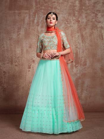 Catch All The Limelight At The Next Wedding You Attend Wearing This Designer Lehenga Choli In Aqua Blue Color Paired With Contrasting Orange Colored Dupatta. Its Blouse Is Art Silk Based Paired With Net Fabricated Lehenga And Dupatta. 