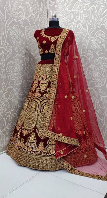 Here Is A Very Beautiful And Heavy Bridal Designer Lehenga Choli In Maroon Color. Its Blouse And Lehenga Are Fabricated On Velvet Paired With Net Fabricated Dupatta. It Is Beautified With Heavy Embroidery Which Gives An Attractive Look To It.