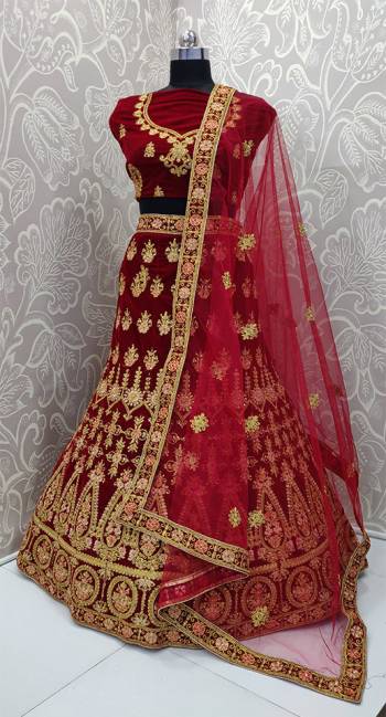 Here Is A Very Beautiful And Heavy Bridal Designer Lehenga Choli In Maroon Color. Its Blouse And Lehenga Are Fabricated On Velvet Paired With Net Fabricated Dupatta. It Is Beautified With Heavy Embroidery Which Gives An Attractive Look To It.