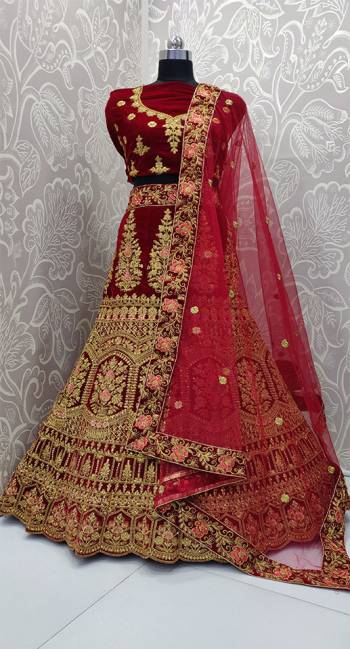 Here Is A Very Beautiful And Heavy Bridal Designer Lehenga Choli In Maroon Color. Its Blouse And Lehenga Are Fabricated On Velvet Paired With Net Fabricated Dupatta. It Is Beautified With Heavy Embroidery Which Gives An Attractive Look To It.