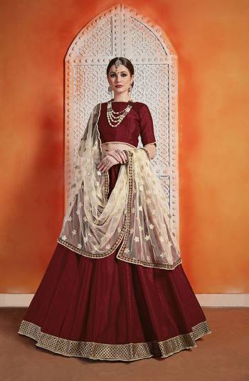 For A Royal Queen Look, Grab This Designer Lehenga Choli Maroon Color Paired With Contrasting Cream Colored Dupatta. This Beautiful Lehenga Choli Is Fabricated On Art Silk Paired With Net Fabricated Dupatta. Buy This Now.