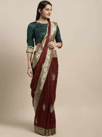 This Festive Season Have A Proper Traditonal Look With This Silk Based Embroidered Saree. This Saree Is In Maroon Color Paired With Contrasting Teal Blue Colored Blouse. It Is Beautified With Lace Border & Embroidered Butti.