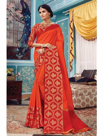 Here Is A Pretty Silk Based Saree In Same Family Color Saree And Blouse. This Pretty Saree Is In Orange Color Paired With Red Colored Blouse. It Is Beautified With Weave Over The Broad Saree Border Giving It An Attractive Look. 