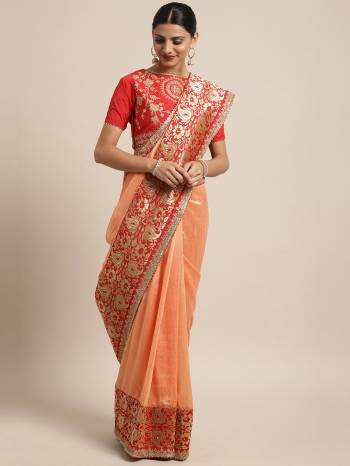 A Must Have Shade In Every Womens Wardrobe Is Here With This Designer Saree In Peach Color Paired With Contrasting Red Colored Blouse. This Saree And Blouse Are Fabricated On Art Silk Beautified With Weave And Embroidery. 