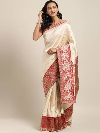 A Must Have Shade In Every Womens Wardrobe Is Here With This Designer Saree In Cream Color Paired With Contrasting Red Colored Blouse. This Saree And Blouse Are Fabricated On Art Silk Beautified With Weave And Embroidery. 