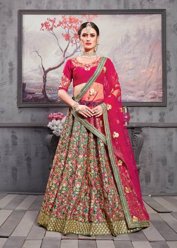 Catch All The Limelight At The Next Wedding You Attend Wearing This Heavy Designer Lehenga Choli In Magenta Pink Colored Blouse And Dupatta Paired With Contrasting Teal Green Colored Lehenga. Its Blouse And Lehenga Are Art Silk Based With Heavy Embroidery All Over The Lehenga And Net Fabricated Dupatta. 