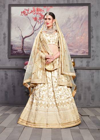 Flaunt Your Rich And Elegant Taste Wearing This Heavy Designer Lehenga Choli In All Over Cream Color. Its Heavy Embroiderd Blouse And Lehenga Are Fabricated On Art Silk Paired With Net Fabricated Dupatta.  Its Lovely Tone To Tone Embroidered Gives A Rich Subtle Look To Your Personality. Buy Now.