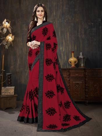 Here Is A Very Pretty Designer Silk Based Saree In Red Color Paired With Black Colored Blouse. It Is Beautified With Black Colored Thread Work Motifs All Over. Also It Is Light In Weight And Easy To Carry Throughout The Gala. Buy Now.