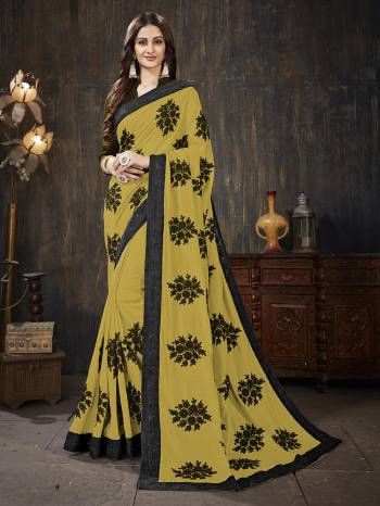 Here Is A Very Pretty Designer Silk Based Saree In Musturd Yellow  Color Paired With Black Colored Blouse. It Is Beautified With Black Colored Thread Work Motifs All Over. Also It Is Light In Weight And Easy To Carry Throughout The Gala. Buy Now.