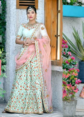 This Season Is About Subtle Shades And Pastel Play, So Grab This Very Beautiful And Heavy Designer Lehenga Choli In Pastel Green Color Paired With Contrasting Pastel Pink Colored Dupatta. Its Heavy Embroidered Blouse And Lehenga Are Fabricated On Art Silk Paired With Net Fabricated Dupatta.