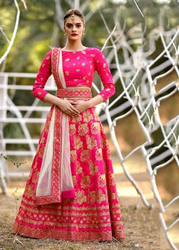 Shine Bright Wearing This Heavy Designer Lehenga Choli In Dark Pink Color Paired With Cream Colored Dupatta. Its Blouse And Lehenga Are Fabricated On Art Silk Paired With Net Fabricated Dupatta. This Pretty lehenga Choli Is Suitable For The Upcoming Wedding And Festive Season. 