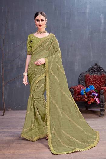 Get Ready For The Upcoming Festive And Wedding Season With This Heavy Designer Saree In Olive Green Color. This Pretty Saree Is Fabricated On Orgenza Paired With Art Silk Fabricated Blouse. It Is Beautified With Heavy Coding Embroidery With Sequence Work. Buy Now.