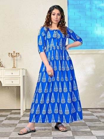 Shine Bright In This Readymade Long Kurti In Royal Blue. This Pretty All Over Printed Kurti Is Fabricated on Muslin Which Is Soft Towards Skin And Easy To Carry All Day Long. 