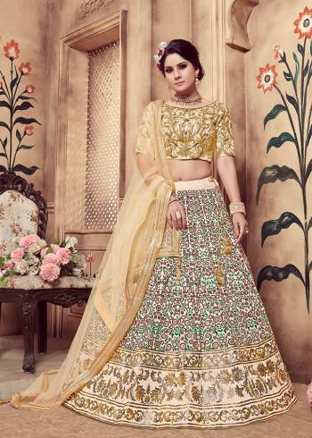 Flaunt You Rich And Elegant Taste Wearing This Heavy Designer Lehenga Choli In All Over Cream Color. This Pretty Embroidered And Foil Printed Lehenga Choli Is Fabricated On Art Silk Paired With Net Fabricated Dupatta. This Rich Color and Fabric Will Earn You Lots Of Compliments From Onlookers. 