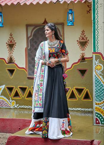 This Navratri, Adorn The Proper Traditional Look Wearing This Designer Lehenga Choli In Black & white Color. This Pretty Lehenga Choli Is Cotton Based Beautified With Multi Colored Thread Embroidery And Mirror Work. 