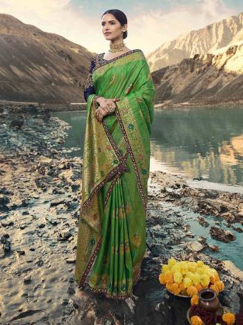 Simple And Elegant Looking Heavy Designer Saree Is Here In Green Color Paired With Contrasting Navy Blue Colored Blouse. This Saree Is Fabricated On Weaving Art Silk Paired With Art Silk Fabricated Blouse. Buy This Lovely Designer Piece Now.