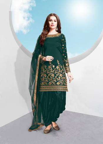 Grab This Attractive Looking Designer Patiala Suit In Teal Green Colored Top , Bottom And Dupatta. Its Top Is Fabricated On Tafeta Silk Beautified With Heavy Jari Embroidery And Mirror Work Paired With Santoon Bottom And Net Fabricated Dupatta. Buy Now.