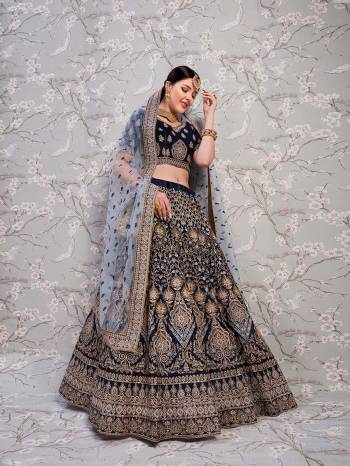 Enhance Your Personality Wearing This Heavy Designer Lehenga Choli In Navy Blue Color Paired With Grey Colored Dupatta. Its Heavy Embroidered Blouse And Lehenga Are Fabricated On Satin Silk Paired With Net Fabricated Dupatta. Its Rich Color Combination And Embroidery Will Earn You Lots of Compliments From Onlookers. 