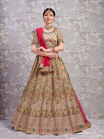 Get Ready For The Upcoming Wedding At Your Place With This Very Beautiful Heavy Designer Lehenga Choli In Beige Color Paired With Dark Pink Colored Blouse. This Heavy Embroidered Lehenga Choli Is Fabricated On Art silk Paired with Net Fabricated Dupatta. 