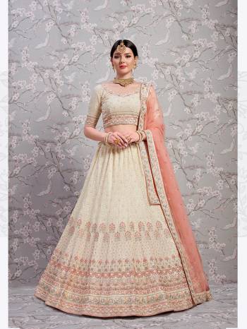 For An Elegant And Subtle Look, Grab This Very Pretty Designer Lehenga Choli In Cream Color Paired With Pastel Peach Colored Dupatta. Its Blouse And Lehenga Are Fabricated On Georgette Paired With Net Fabricated Dupatta. This Heavy Lehenga Choli Gives A Subtle And Heavy Look Both At The Same Time. 