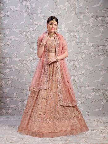 You Will Definitely Earn Lots Of Compliments In This Lovely Color Pallete Of Dusty Pink Colored Blouse, Lehenga And Dupatta. This Lehenga Choli Is Fabricated On Georgette Paired With Net Fabricated Dupatta. It Is Beautified With Contrasting And Tone To Tone Resham Embroidery And Stone Work. 