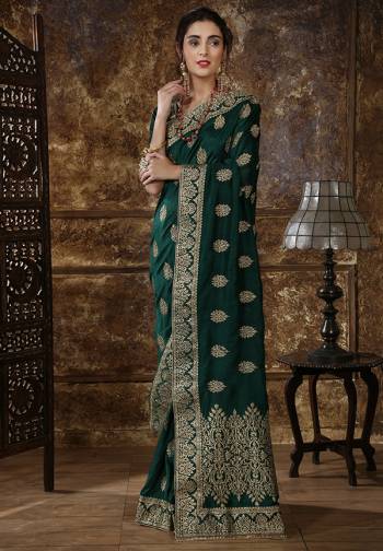 Celebrate This Festive And Wedding Season Wearing This Designer Silk Based Saree In Pine Green Color Paired With Pine Green Colored Blouse. It Is Beautified With Heavy Jari Embroidery And Stone Work. 