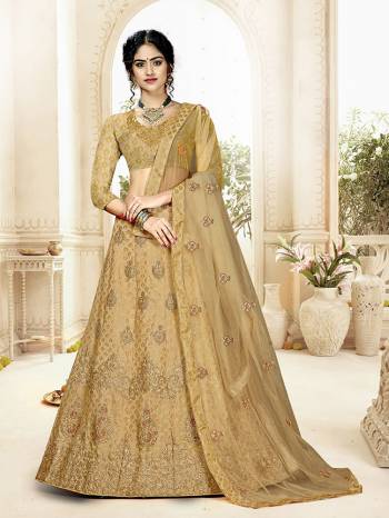 Grab This Heavy Designer Lehenga Choli In All Over Beige Color. Its Blouse Is Fabricated On Art Silk Paired With Jacquard Silk Fabricated Lehenga And Net Fabricated Dupatta. It Is Beautified With Weave And Embroidery Which Is Making It More Attractive. 