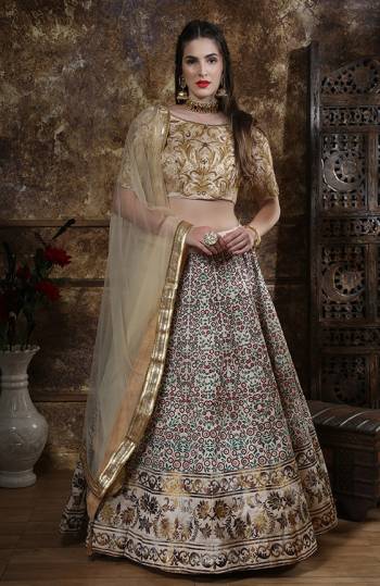 Flaunt Your Rich And Elegant Taste Wearing This Heavy Designer Lehenga Choli In Cream Colored Blouse Paired With Off-White Lehenga And Dupatta. Its Blouse And Lehenga are Fabricated On Art Silk Paired With Net Fabricated Dupatta. 