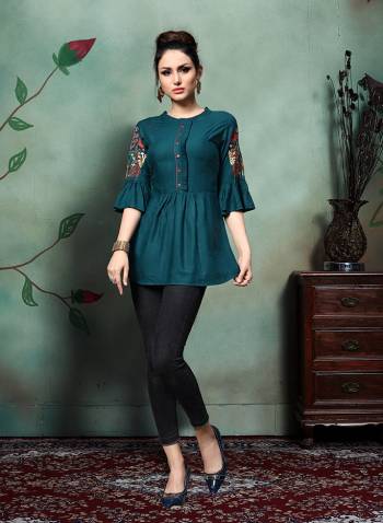 Enhance Your Personality Wearing This Designer Readymade Top In Teal Blue Color Fabricated On Rayon. This Pretty Top Is Beautified With Contrasting Colored Thread Work Over The Sleeves. Buy Now.