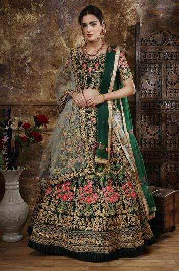 Get Ready For The Upcoming Wedding Season With This Heavy Designer Lehenga Choli In Dark Green Color. Its Heavy Embroidered Blouse And Lehenga Are Fabricated Satin Silk Paired With Net Fabricated Dupatta. Its Heavy And Attractive Embroidery will Definitely Earn You Lots Of Compliments From Onlookers. 