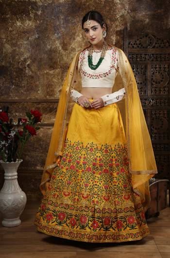 This Festive Season, Be The Most Glamours Diva Wearing This Heavy Designer Lehenga Choli In Off-White Colored Blouse Paired With Yellow Colored Lehenga And Dupatta. This Lehenga Choli Is Fabricated On Art Silk Paired With Net Dupatta. 