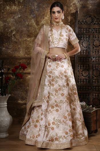 For a Rich Subtle Look, Grab This Heavy Designer Lehenga Choli In Off-White Color Paired With Peach Colored Dupatta. Its Heavy Embroidered Blouse And Lehenga Are Fabricated On Art Silk Paired With Net Fabricated Dupatta. Its Rich Color Pallete And Silk based Fabric Will Give A Rich Look To Your Personality. Buy Now.