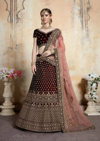 Get Ready For Your D-day With This Heavy Designer Bridal Lehenga?choli In Maroon Color Paired With Contrasting Peach Colored Dupatta. This Velvet Based Lehenga And Choli Are Beautified With Heavy Jari And Resham Embroidery With Stone Work. Its Fabric Also Ensures Superb Comfort Throughout The Gala And Earn You Lots Of Compliments From Onlookers. Buy This Bridal Lehenga Choli Now.