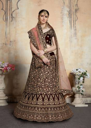 Get Ready For Your D-day With This Heavy Designer Bridal Lehenga?choli In Maroon Color Paired With Contrasting Peach Colored Dupatta. This Velvet Based Lehenga And Choli Are Beautified With Heavy Jari And Resham Embroidery With Stone Work. Its Fabric Also Ensures Superb Comfort Throughout The Gala And Earn You Lots Of Compliments From Onlookers. Buy This Bridal Lehenga Choli Now.