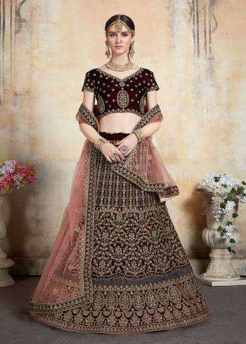 Get Ready For Your D-day With This Heavy Designer Bridal Lehenga?choli In Maroon Color Paired With Contrasting Peach Colored Dupatta. This Velvet Based Lehenga And Choli Are Beautified With Heavy Jari And Resham Embroidery With Stone Work. Its Fabric Also Ensures Superb Comfort Throughout The Gala And Earn You Lots Of Compliments From Onlookers. Buy This Bridal Lehenga Choli Now.