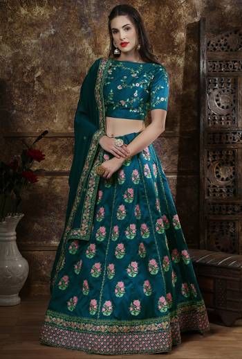 Add This Pretty Shade To Your Wardrobe With This Heavy designer Lehenga Choli In All Over Teal Blue Color. This Embroidered Lehenga And Choli are Fabricated On Art Silk Paired With Georgette Fabricated Dupatta. 