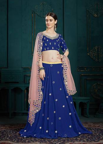 You Will Definitely Earn Lots Of Compliments Wearing This Designer Lehenga Choli In Royal Blue Color Paired Contrasting Baby Pink Colored Dupatta. It Is Beautified With Attractive Mirror Work And Cutwork Dupatta. Its Lovely Color Pallete And Embroidery Give You A Look Like Never Before. 