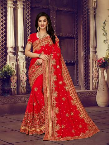 For The Upcoming Wedding Season, Here Is a Perfectly Suitable Saree In Red Color Paired With Red Colored Blouse. This Saree And Blouse Are fabricated On Georgette Beautified With Embroidery Highlighted With Stone Work. Buy This Beautiful Designer Saree Now.