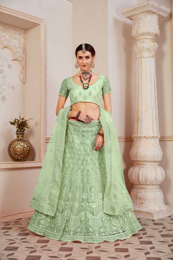 This Wedding Season Be The Most Sensational Diva Wearing This Heavy Designer Lehenga Choli In Light Green Color. This Pretty Blouse, Lehenga And Dupatta Are Fabricated On Net Beautified With Tone To Tone Coding And Resham Embroidery With Stone Work. Buy This Designer Piece Now.