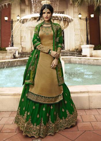 Celebrate This Festive And Wedding Season With This designer Indo-Western Lehenga Suit In Dark Beige Colored Top Paired With Contrasting Green Colored Lehenga And Dupatta. Its Top Is Satin Georgette Based Paired With Net Fabricated Lehenga And Dupatta.