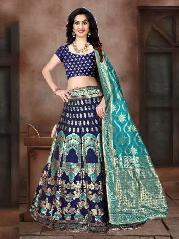 Go With Pretty Shades Of Blue Wearing This Heavy Weaved Designer Lehenga Choli In Navy Blue Color Paired With Blue Colored Dupatta. Its Blouse Is Fabricated On Banarasi Art Silk Paired With Banarasi Jacquard Silk  Lehenga And Dupatta. 