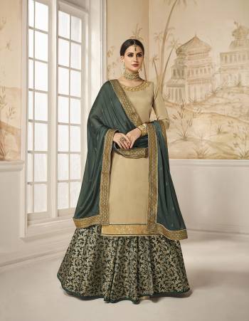 Flaunt Your Rich And Elegant Taste Wearing This Designer Indo-Western Suit In Beige Colored Top Paired With Contrasting Dark Teal Green Colored Bottom And Dupatta. Its Embroidered Top Is Fabricated On Satin Silk Paired With Jacquard Silk Bottom And Georgette Silk Fabricated Dupatta. As Per Your Choice You Can Its Bottom Stitched As A Plazzo Or Skirt. 