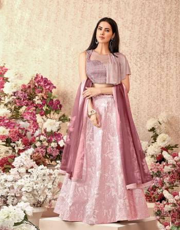 Here Is A subtle, simple and dreamy pink lehenga paired with a stylish assymetric draped blouse will take your fashion  nuances a step higher. Opt for statement fashion jewelry to look ethereal.